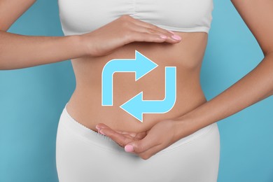 Image of Woman with healthy digestion on light blue background, closeup. Arrows symbolizing proper functioning of digestive tract