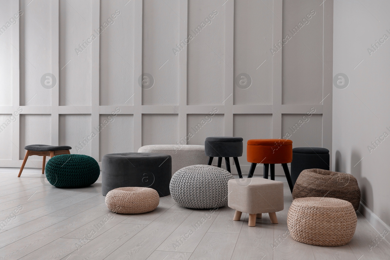 Photo of Different stylish poufs and ottomans in room