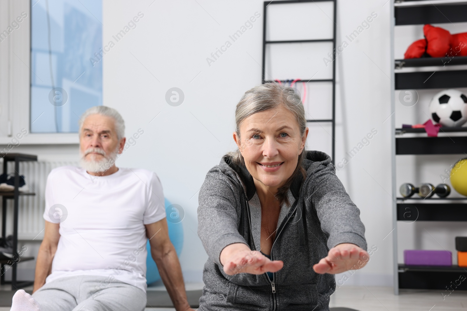 Photo of Elderly couple exercising at home. Healthy leisure