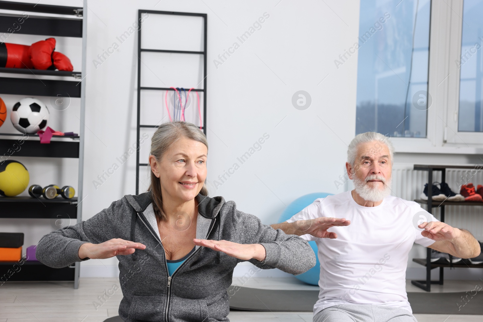 Photo of Elderly couple exercising at home. Healthy leisure