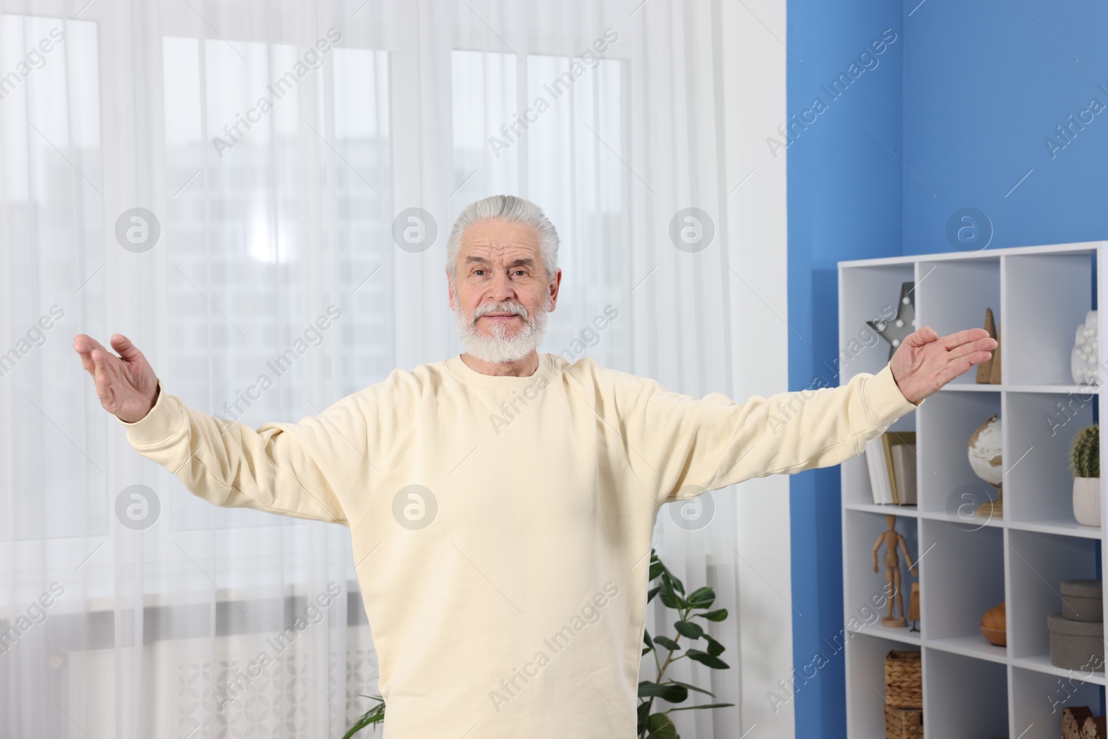 Photo of Elderly man exercising at home. Healthy leisure