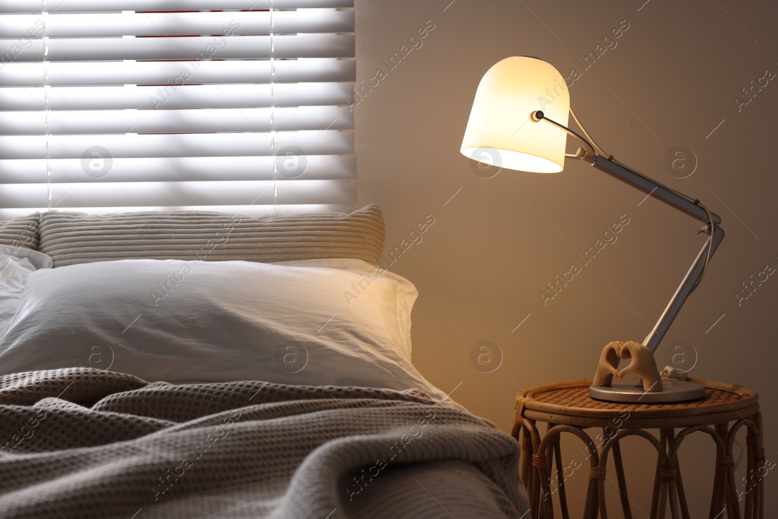 Photo of Glowing night lamp on bedside table indoors