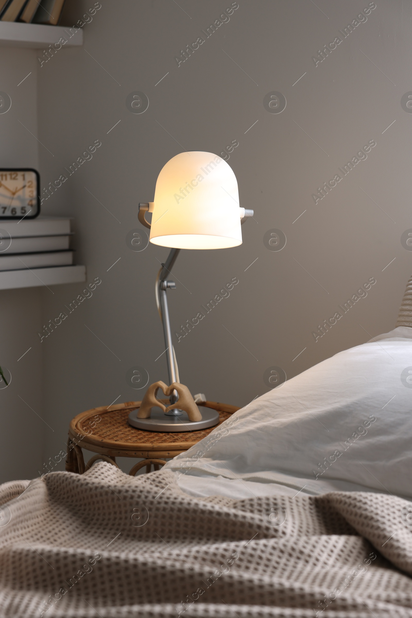 Photo of Glowing night lamp on bedside table indoors