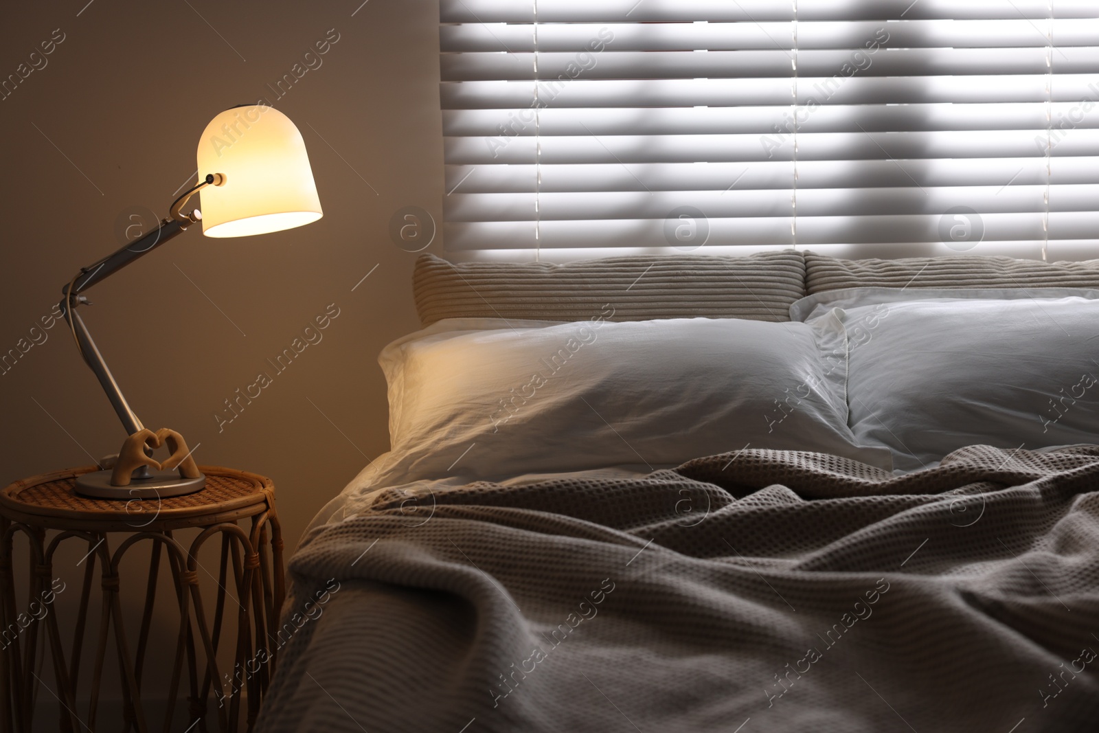 Photo of Glowing night lamp on bedside table indoors