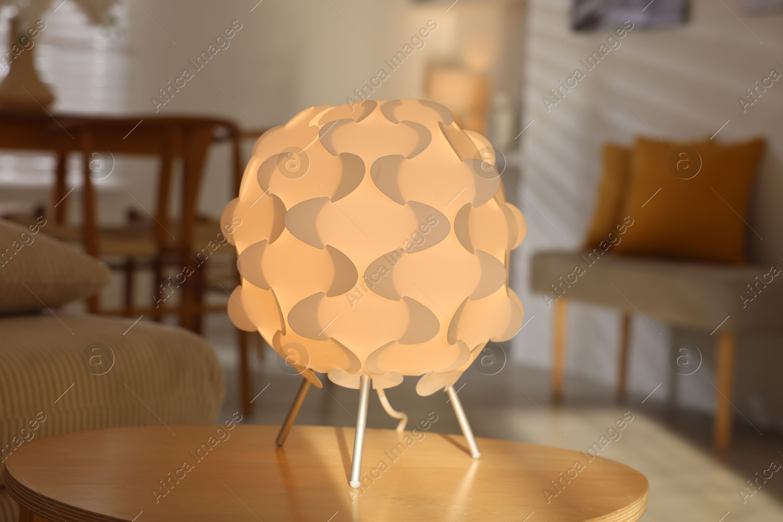 Photo of Glowing night lamp on wooden table at home