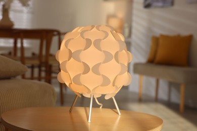 Photo of Glowing night lamp on wooden table at home