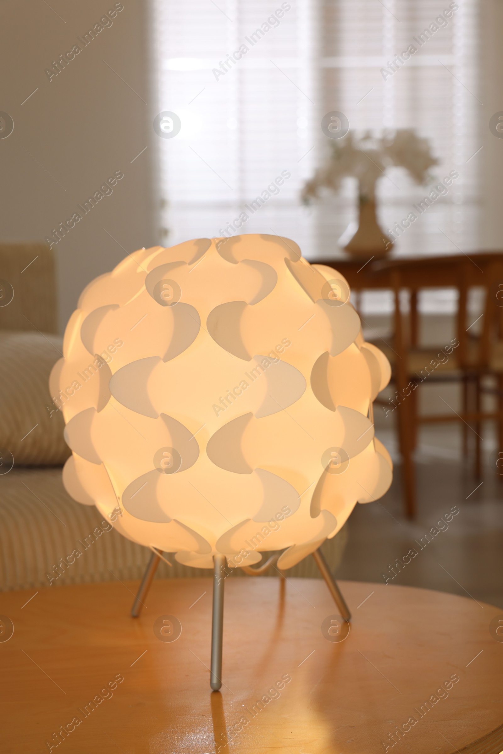 Photo of Glowing night lamp on wooden table at home