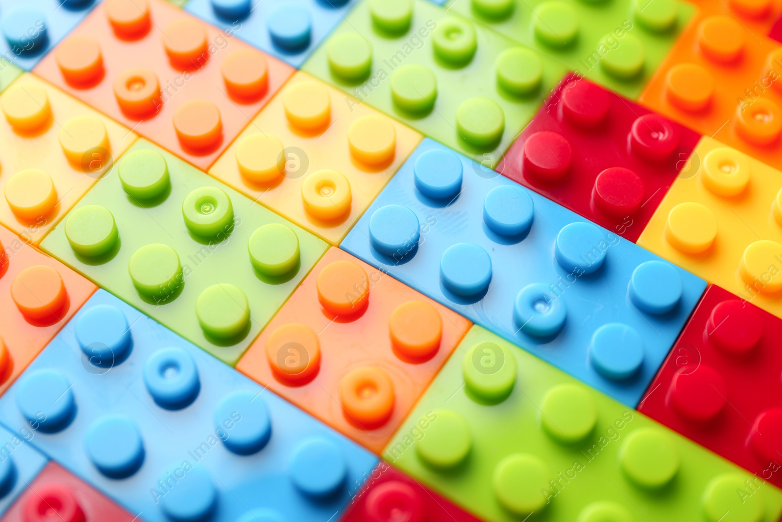 Photo of Constructor toy. Many colorful building blocks as background, closeup