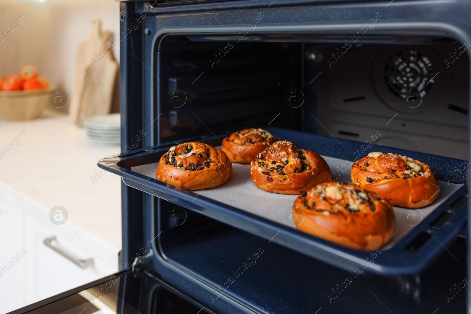 Photo of Baking pan with sweet buns in oven indoors