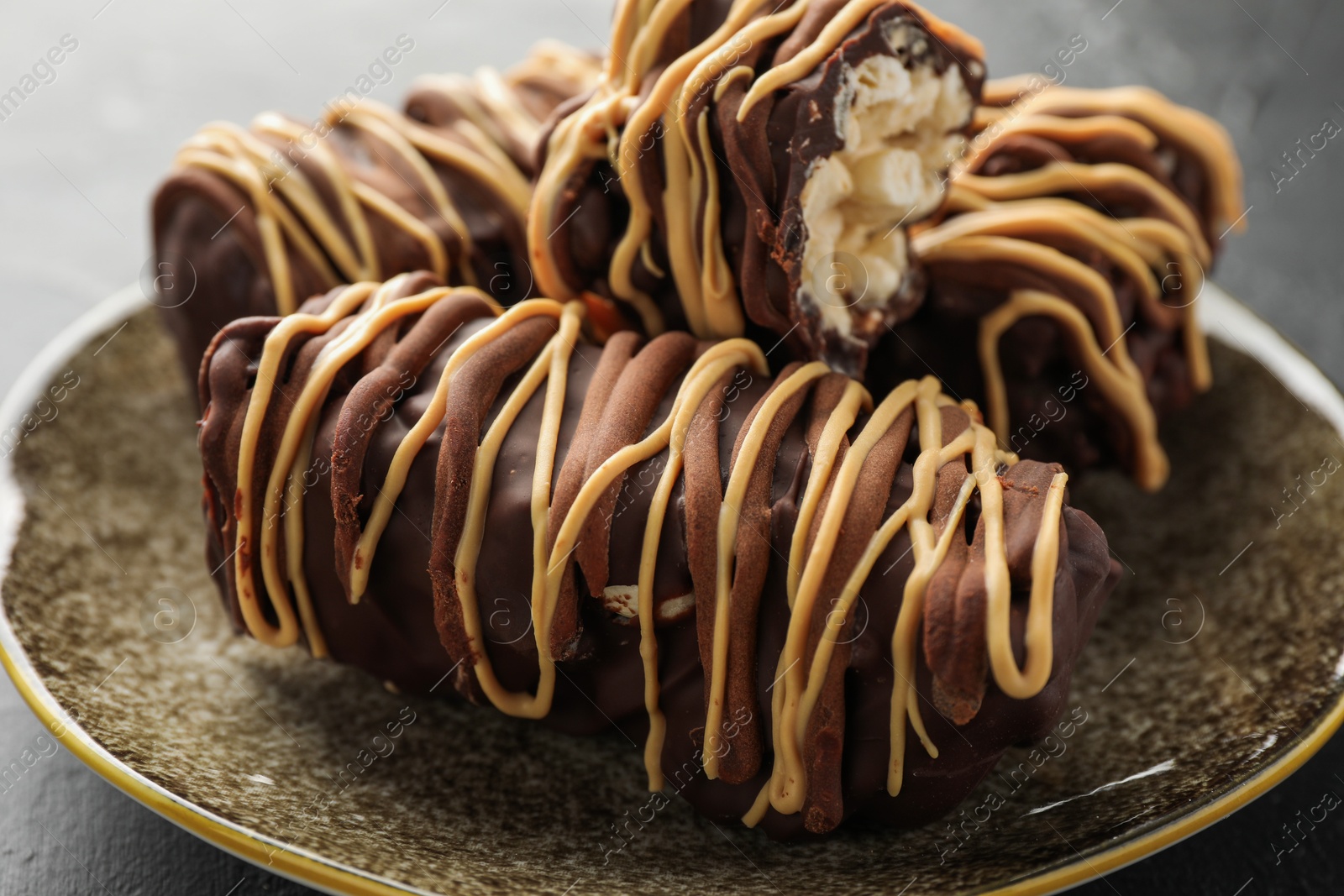 Photo of Delicious chocolate puffed rice bars on gray table, closeup