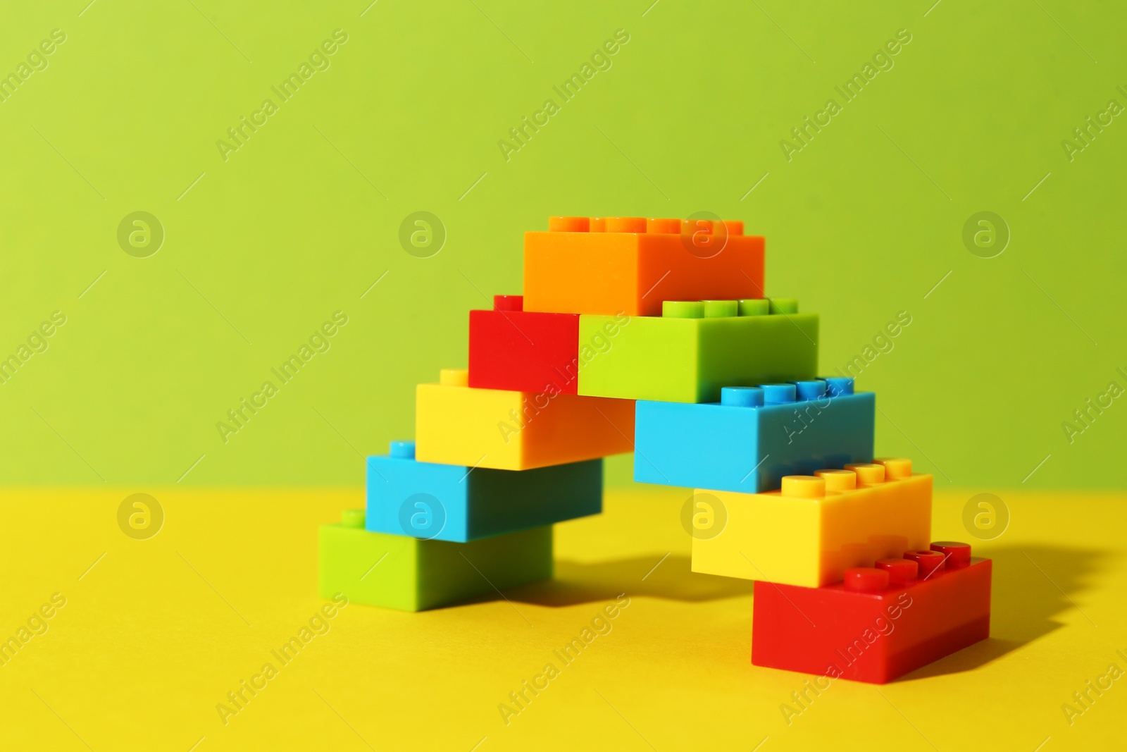 Photo of Construction toy. Figure made with building bricks on color background