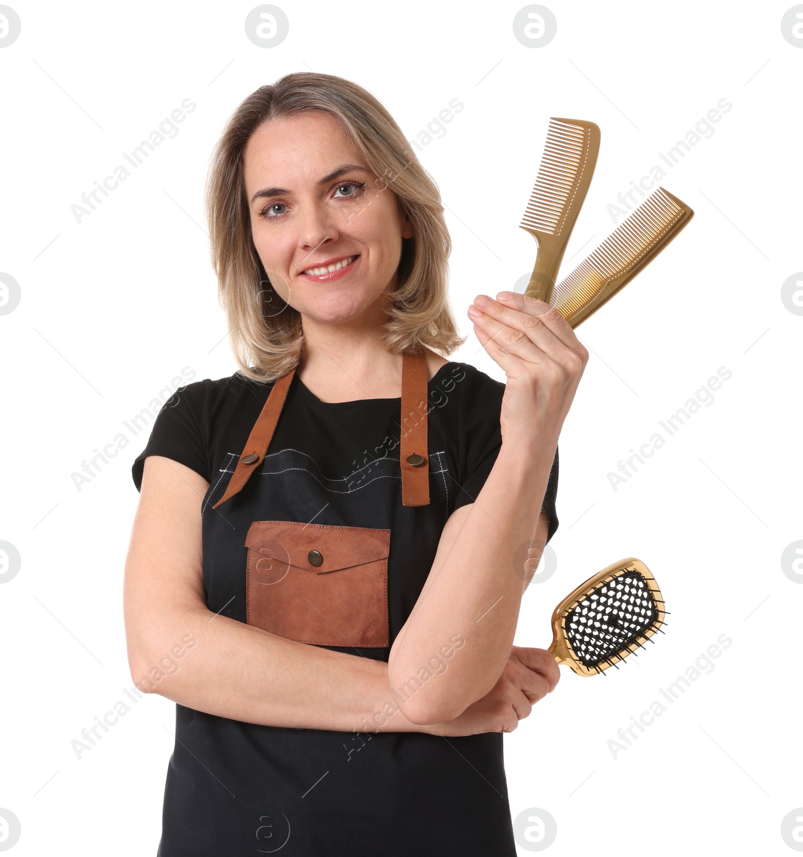 Photo of Smiling hairdresser with combs and brush on white background