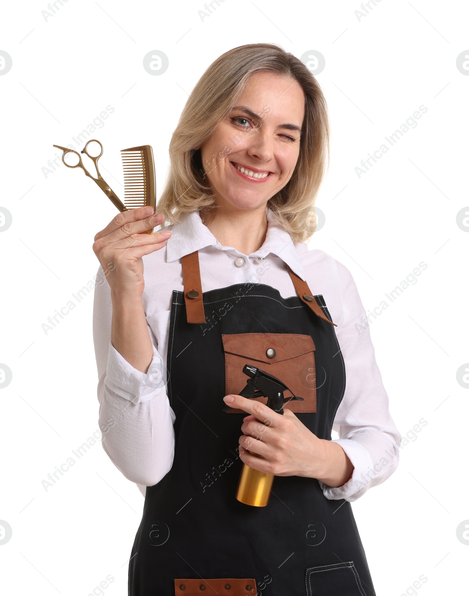 Photo of Smiling hairdresser with scissors, comb and spray bottle on white background