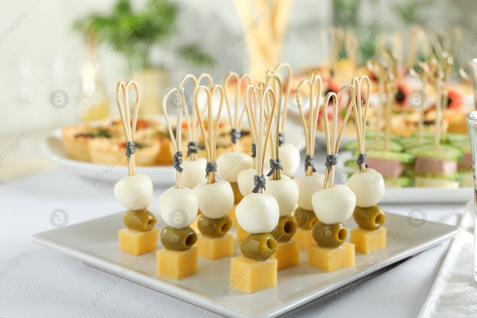 Photo of Many different tasty canapes on white table, closeup