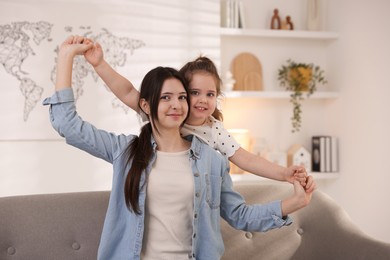 Photo of Portrait of cute little girl and her sister indoors