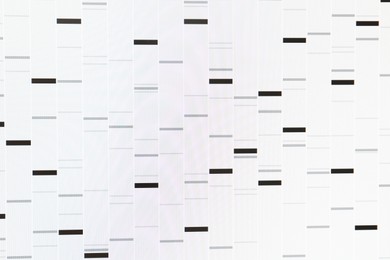 Photo of DNA analysis. Data with genetic information as background, closeup