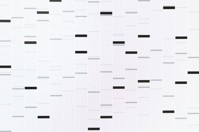 Photo of DNA analysis. Data with genetic information as background, closeup