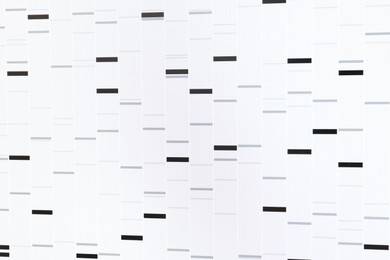 Photo of DNA analysis. Data with genetic information as background, closeup