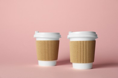 Photo of Paper cups on pink background. Mockup for design