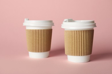Photo of Paper cups on pink background. Mockup for design