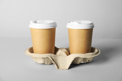 Photo of Paper cups with lids on grey background, closeup. Mockup for design