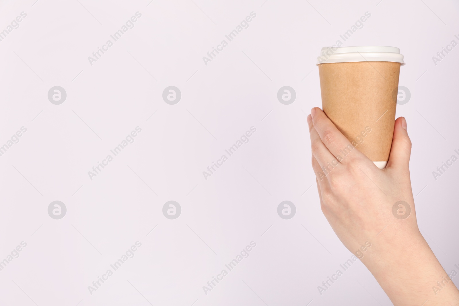 Woman holding paper cup on white background, closeup. Mockup for design Photo of Woman holding paper cup on white background, closeup. Mockup for design
