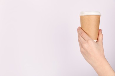 Photo of Woman holding paper cup on white background, closeup. Mockup for design