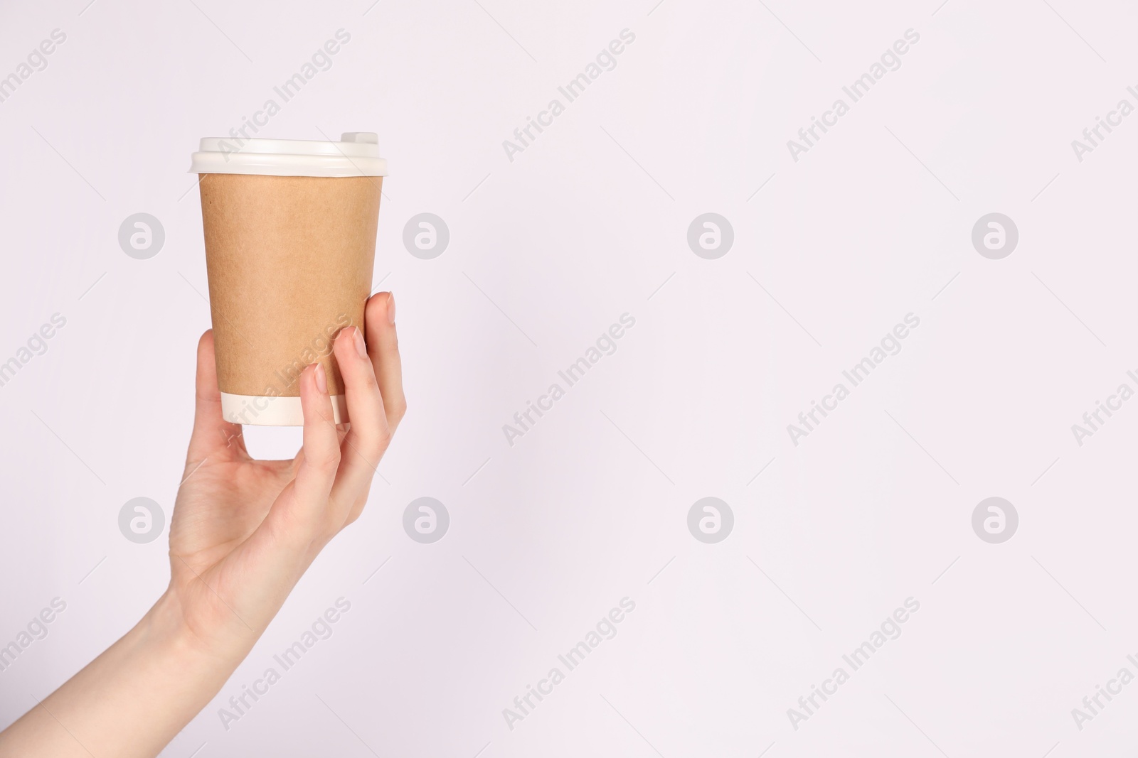 Woman holding paper cup on white background, closeup. Mockup for design Photo of Woman holding paper cup on white background, closeup. Mockup for design