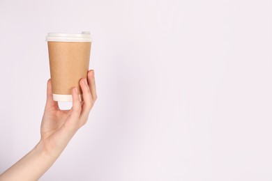 Photo of Woman holding paper cup on white background, closeup. Mockup for design