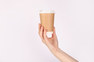 Photo of Woman holding paper cup on white background, closeup. Mockup for design