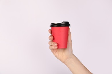 Photo of Woman holding paper cup on white background, closeup. Mockup for design