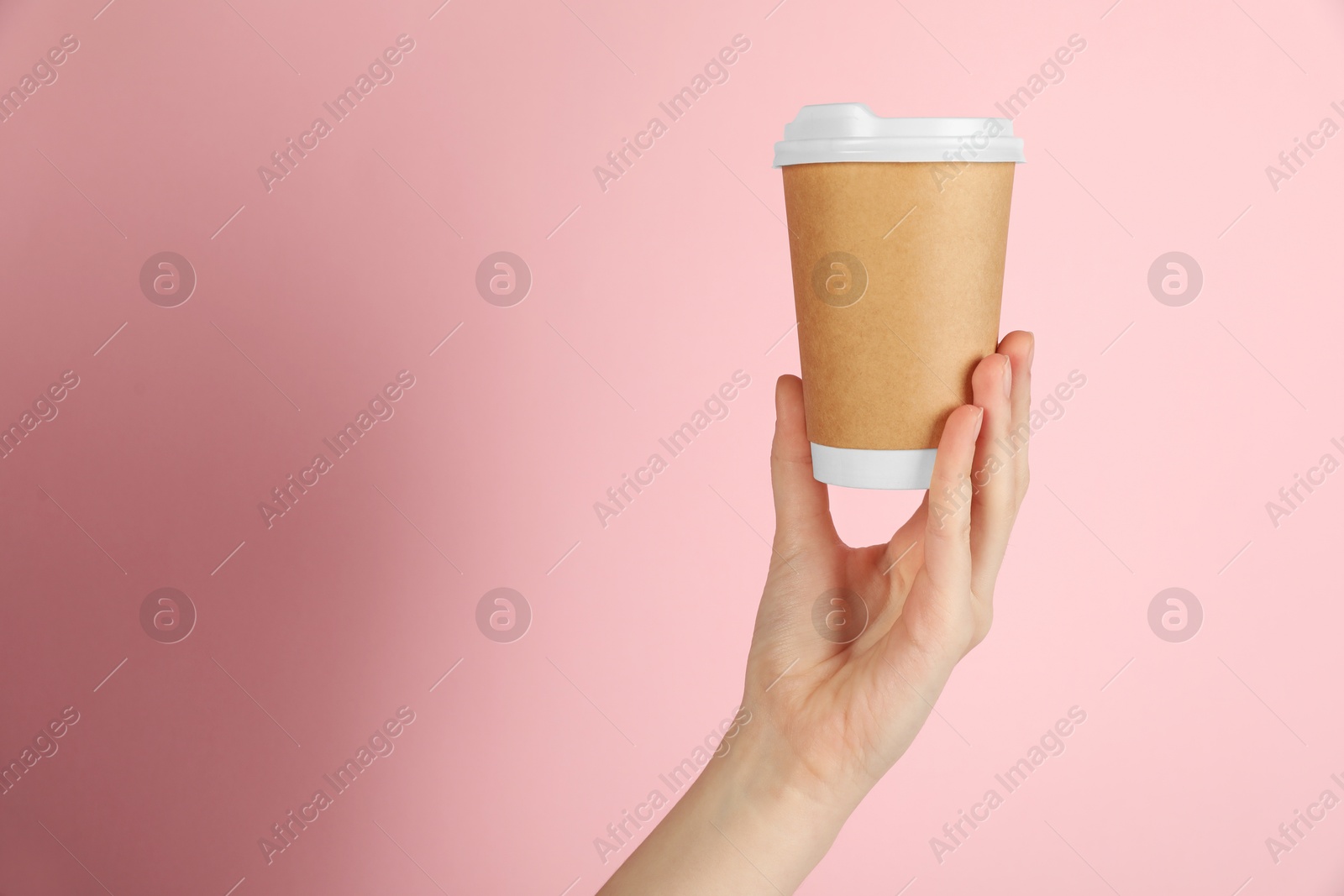 Woman holding paper cup on pink background, closeup. Mockup for design Photo of Woman holding paper cup on pink background, closeup. Mockup for design