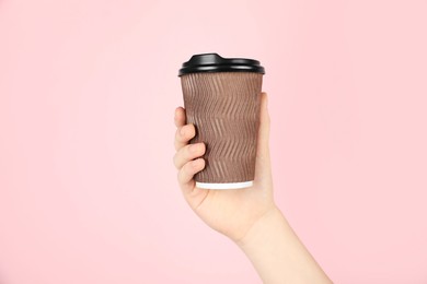 Photo of Woman holding paper cup on pink background, closeup. Mockup for design