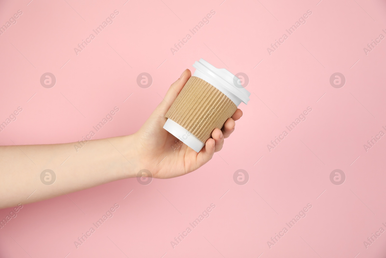 Woman holding paper cup on pink background, closeup. Mockup for design Photo of Woman holding paper cup on pink background, closeup. Mockup for design