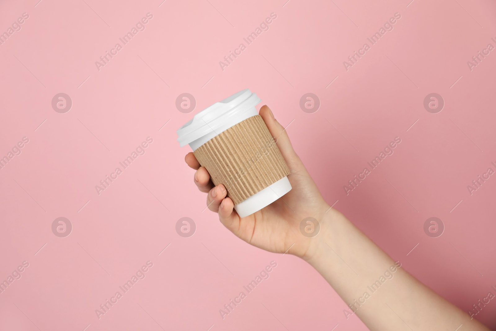 Woman holding paper cup on pink background, closeup. Mockup for design Photo of Woman holding paper cup on pink background, closeup. Mockup for design