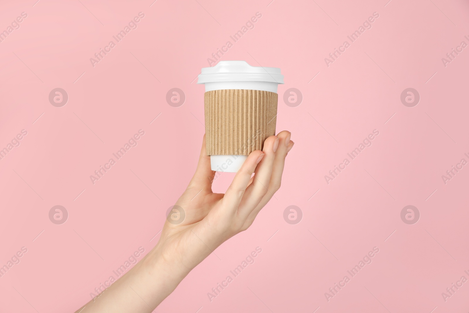 Woman holding paper cup on pink background, closeup. Mockup for design Photo of Woman holding paper cup on pink background, closeup. Mockup for design