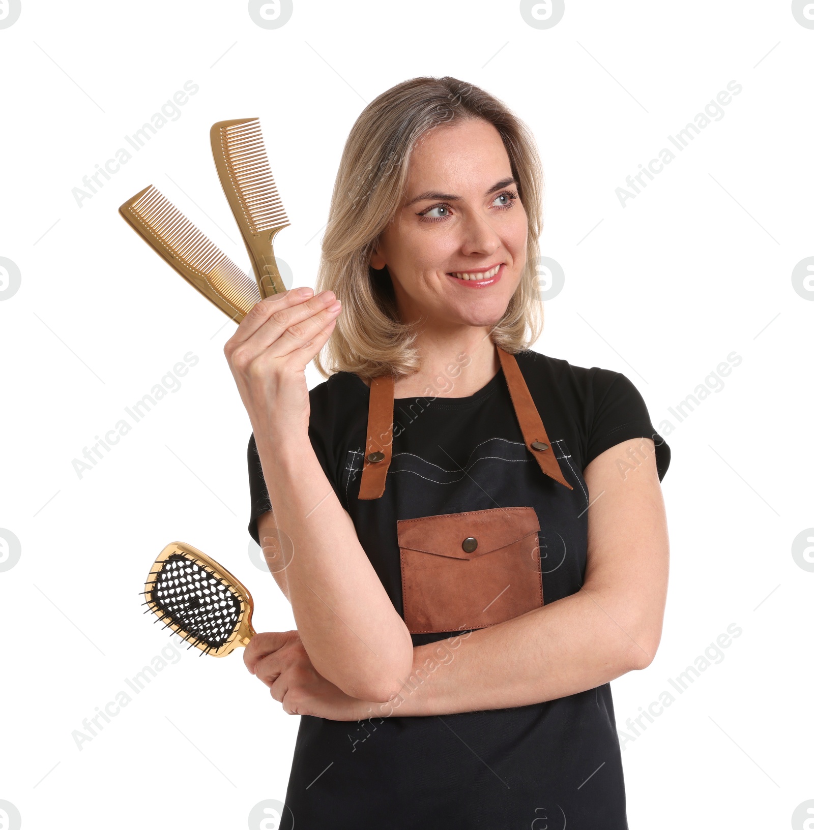 Photo of Smiling hairdresser with combs and brush on white background