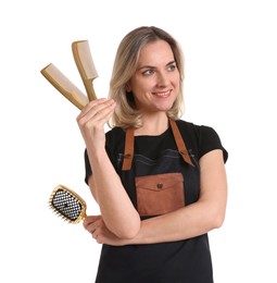 Photo of Smiling hairdresser with combs and brush on white background