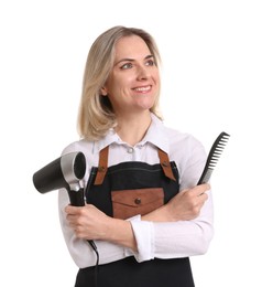 Photo of Smiling hairdresser with comb and dryer on white background