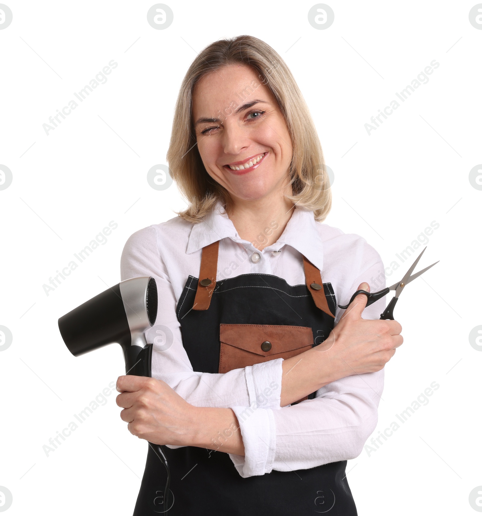 Photo of Smiling hairdresser with dryer and scissors on white background