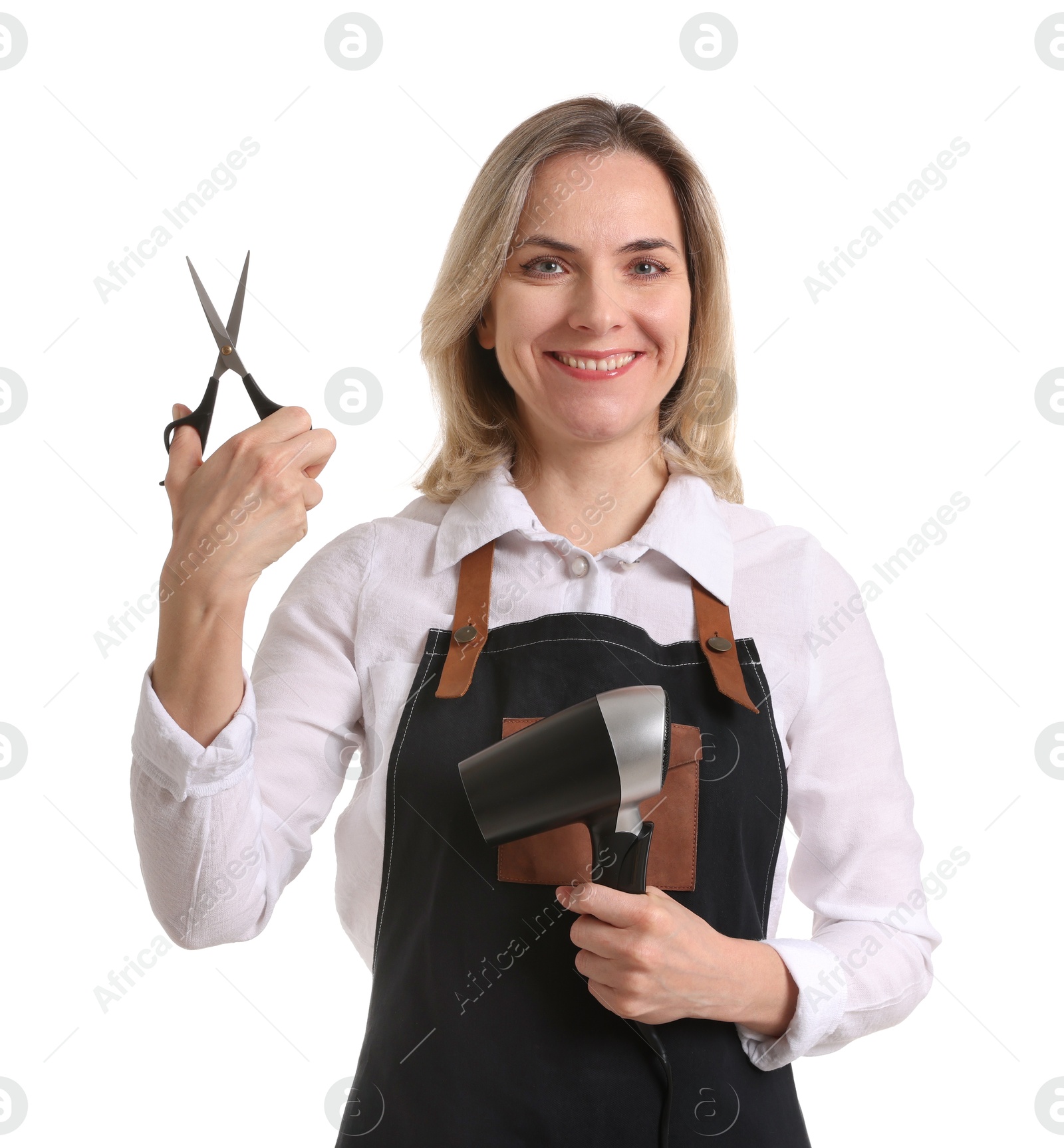 Photo of Smiling hairdresser with dryer and scissors on white background