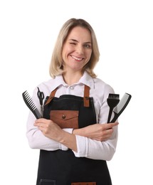 Photo of Smiling hairdresser with combs, hair dye brush and scissors on white background