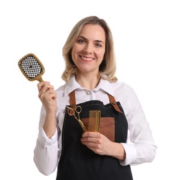 Photo of Smiling hairdresser with brush, scissors and comb on white background