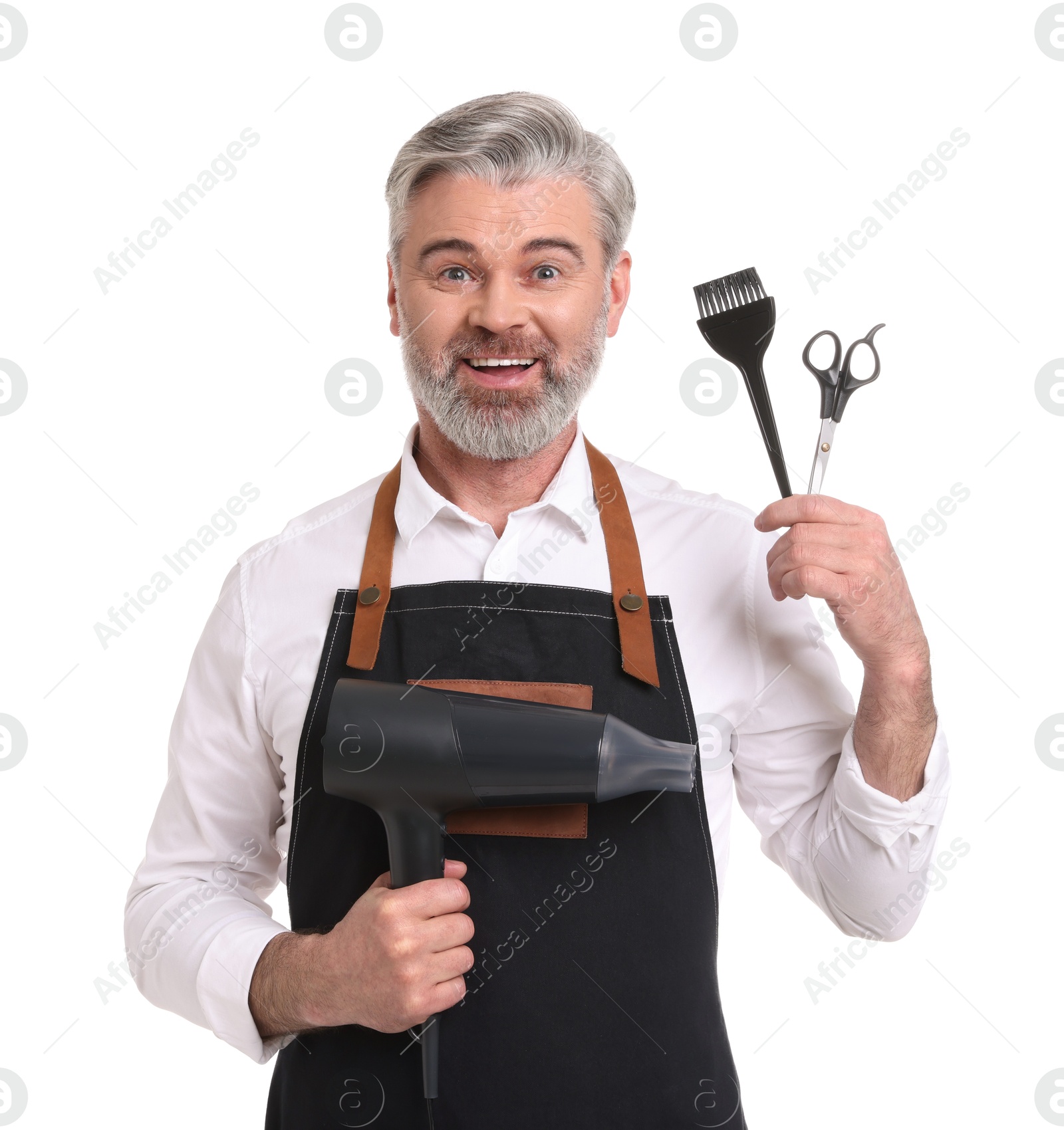 Photo of Smiling hairdresser with dryer, scissors and hair dye brush on white background