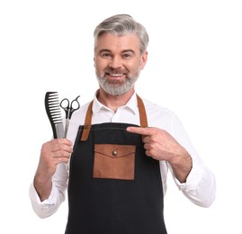 Photo of Smiling hairdresser with comb and scissors on white background