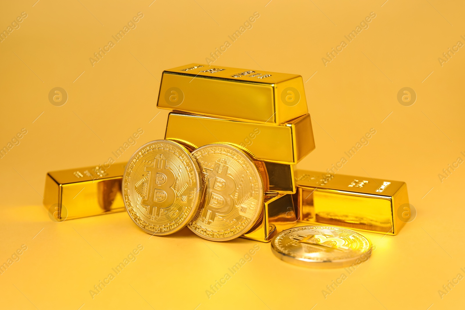 Photo of Gold bars and coins on golden background