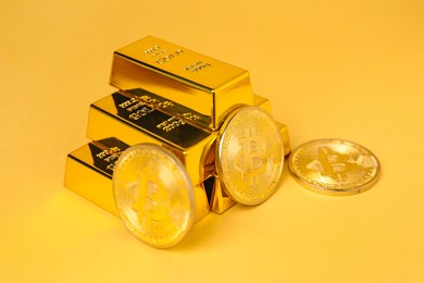 Photo of Gold bars and coins on golden background, closeup