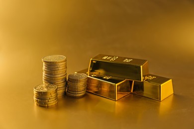 Photo of Gold bars and coins on shiny background