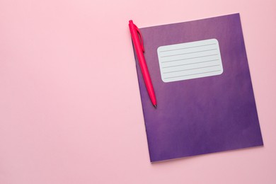 Photo of Copybooks and pen on pink background, top view. Space for text