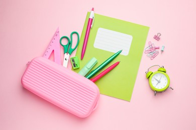 Photo of Copybooks and other school stationery on pink background, flat lay